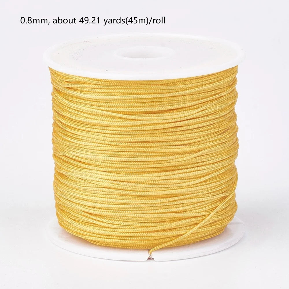 A spool of 0.8mm yellow nylon cord for jewelry making and crafting.