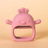 A pink silicone teether shaped like a chick with a textured top and small ears.