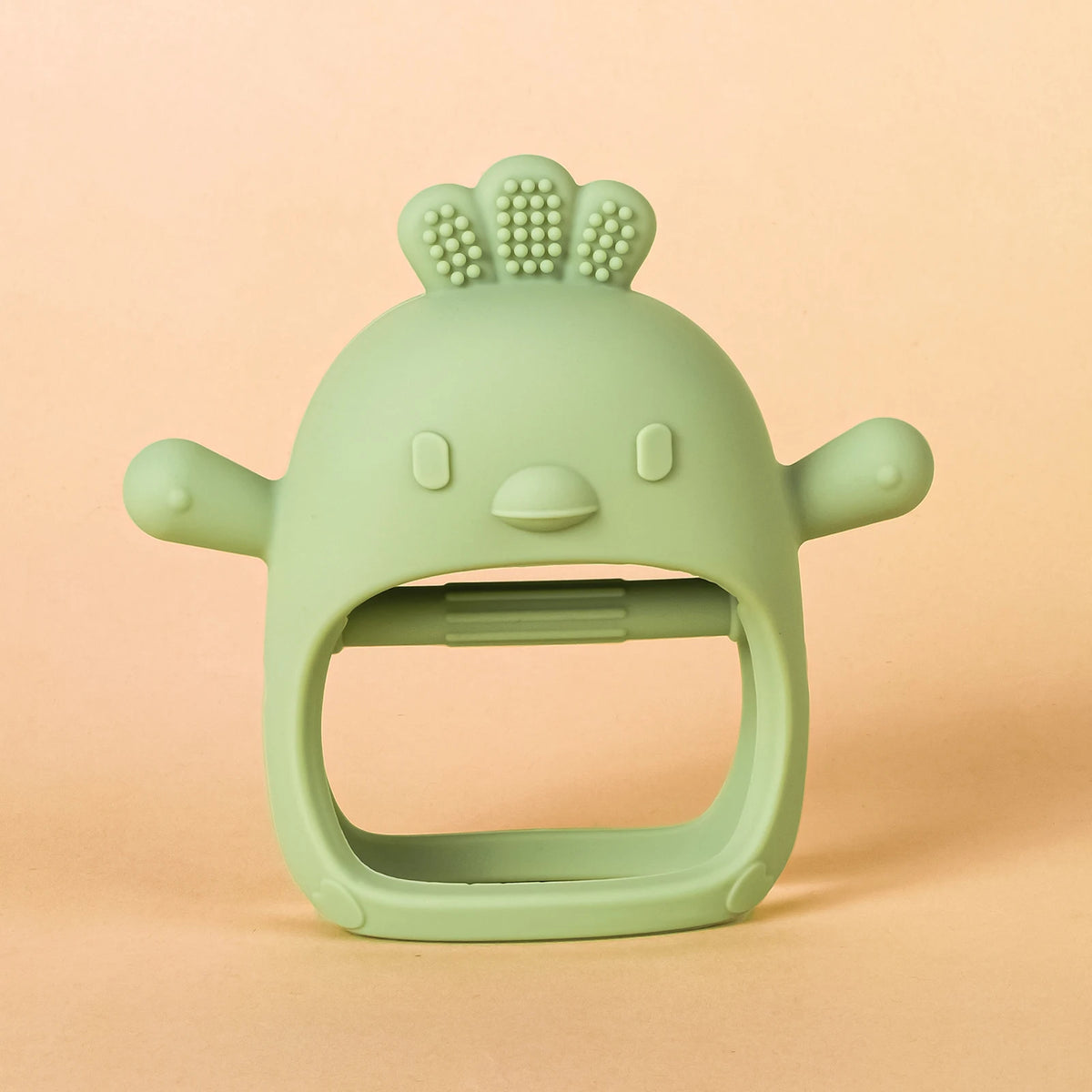 A light green silicone teether shaped like a chick with a wide opening for baby gums.