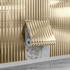 A close-up of a gold vertical wood grain grille wall sticker applied to a textured gray surface.