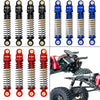Set of aluminum shock absorbers for 1/24 RC crawlers, featuring coiled springs and mounting hardware.