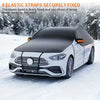 A white car is shown covered with a black elastic strap wind shield cover in a snowy outdoor setting.
