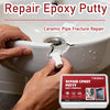 Hands are applying epoxy putty to repair a crack in a ceramic pipe, demonstrating a plumbing repair.