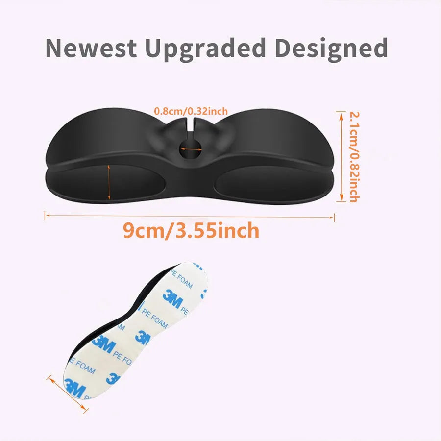 Black adhesive cord organizer featuring foam and plastic components for managing kitchen appliance cords.