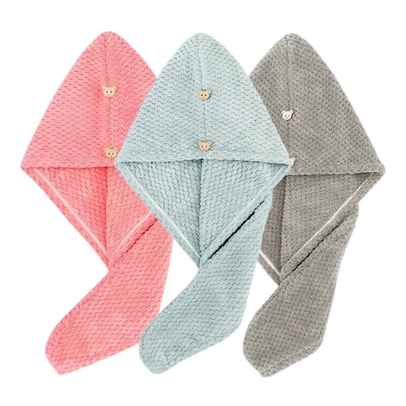 Three folded ultra-soft microfiber hair drying towels in pink, mint green, and gray.