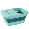 A teal collapsible foot spa bucket with a contoured design for massage and soaking.