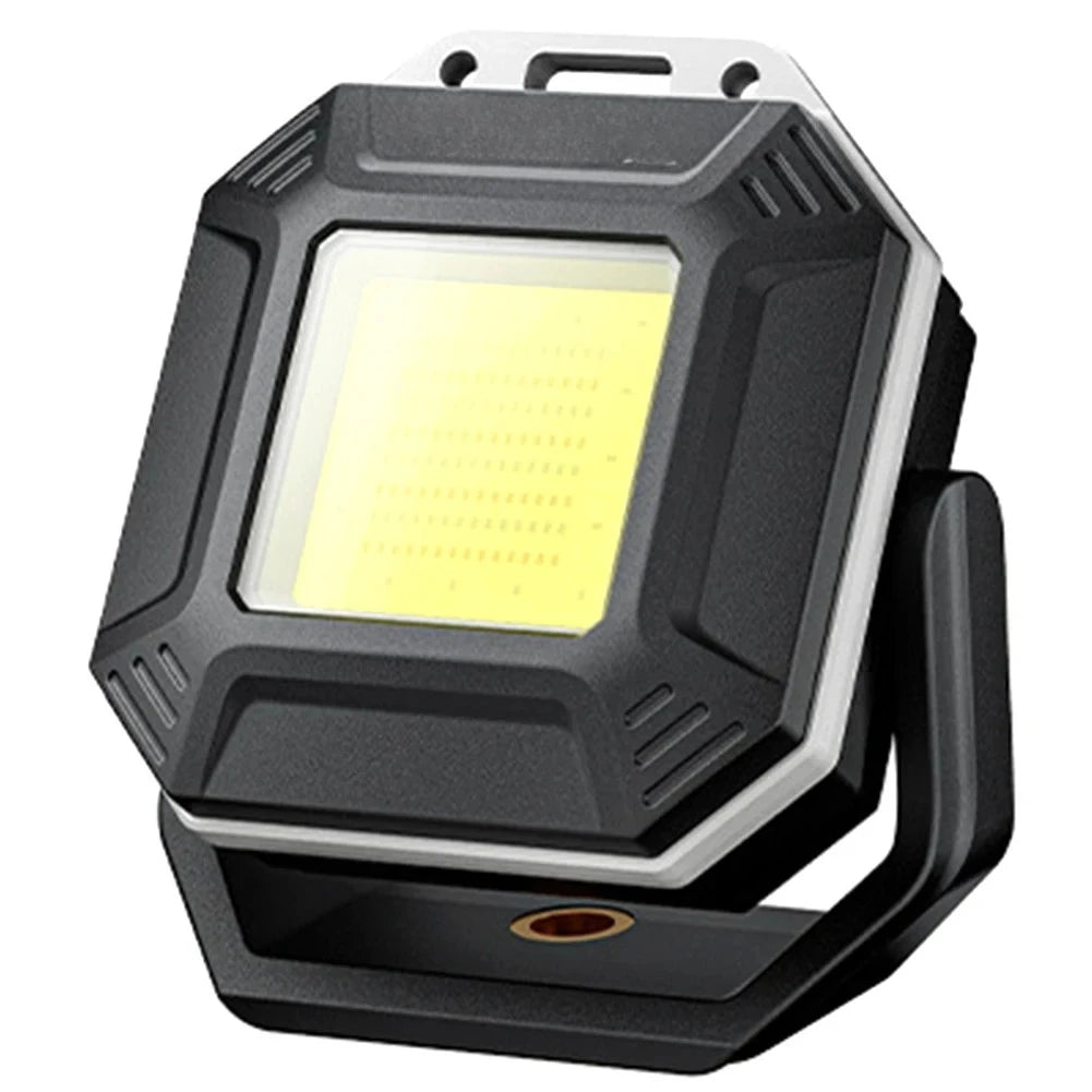 A black rechargeable LED work light with a square housing and magnetic base.
