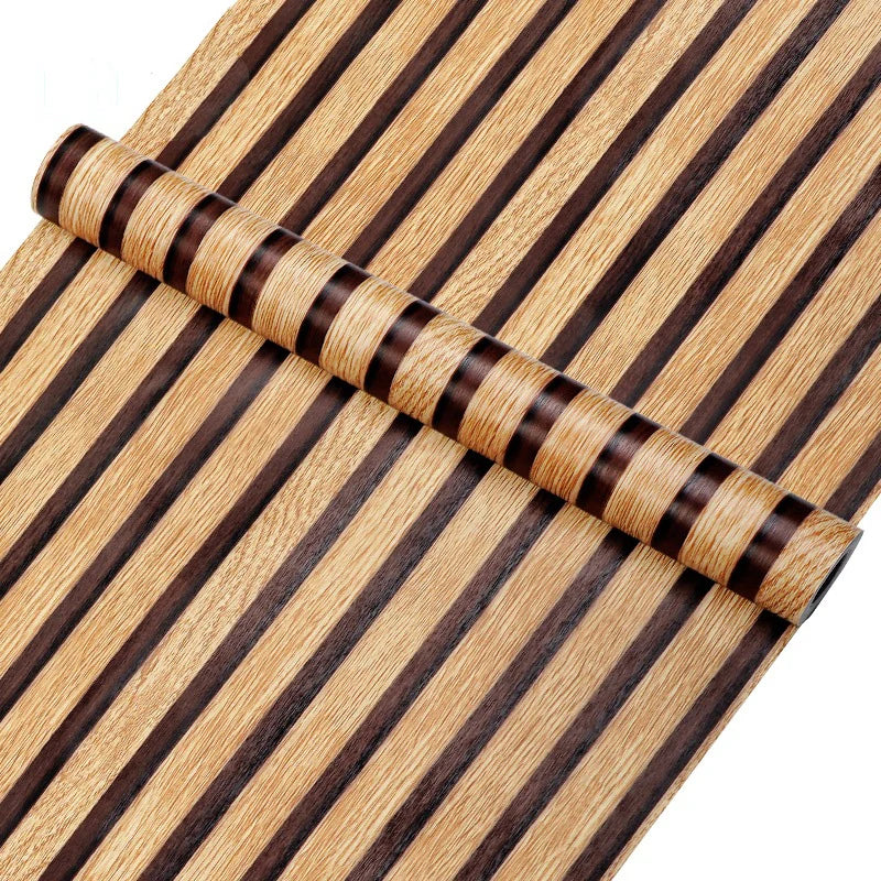 A roll of striped peel-and-stick wallpaper featuring brown and beige wood grain patterns.