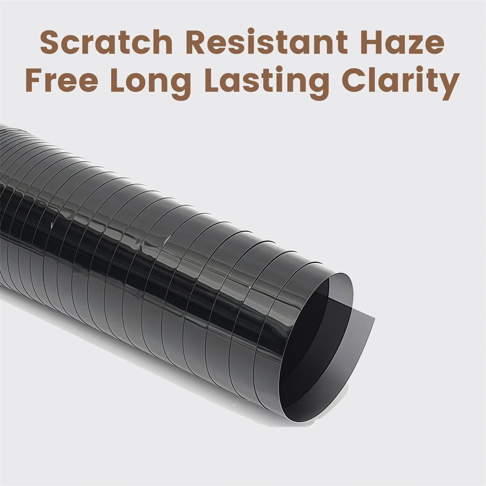 A roll of black scratch resistant window tint film is shown in a side view.