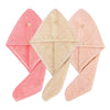 Three folded pink and beige microfiber hair drying towels with secure button closures