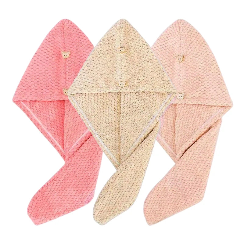 Three folded pink and beige microfiber hair drying towels with secure button closures