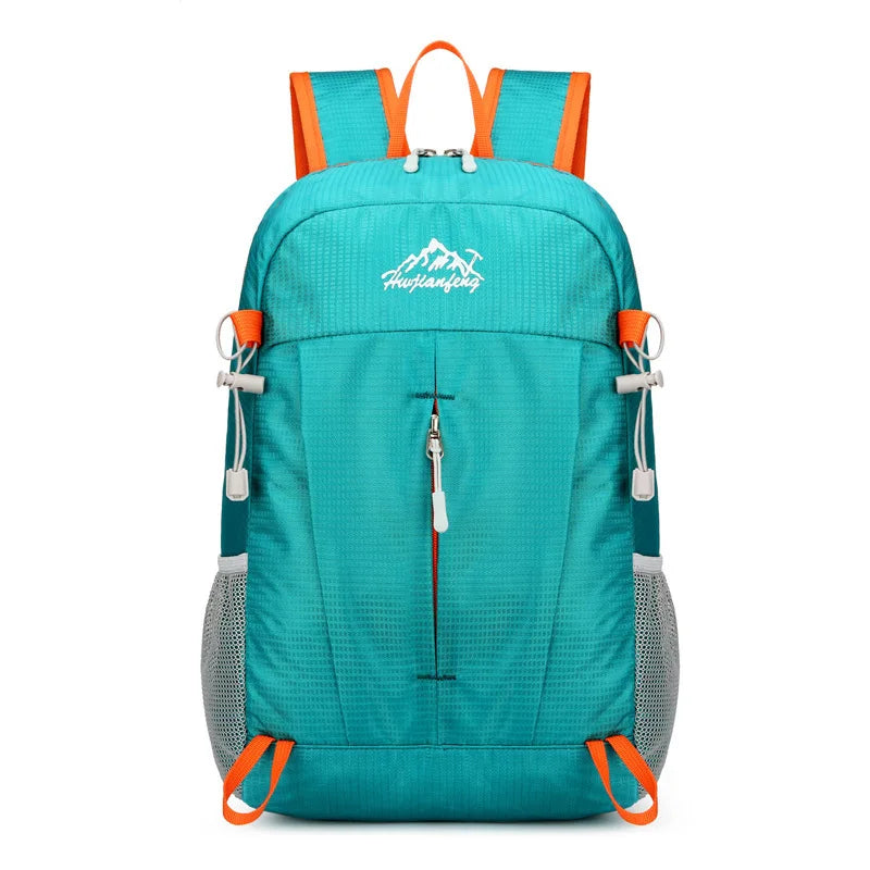 A teal backpack with orange accents and gray mesh panels, designed for travel and outdoor activities.
