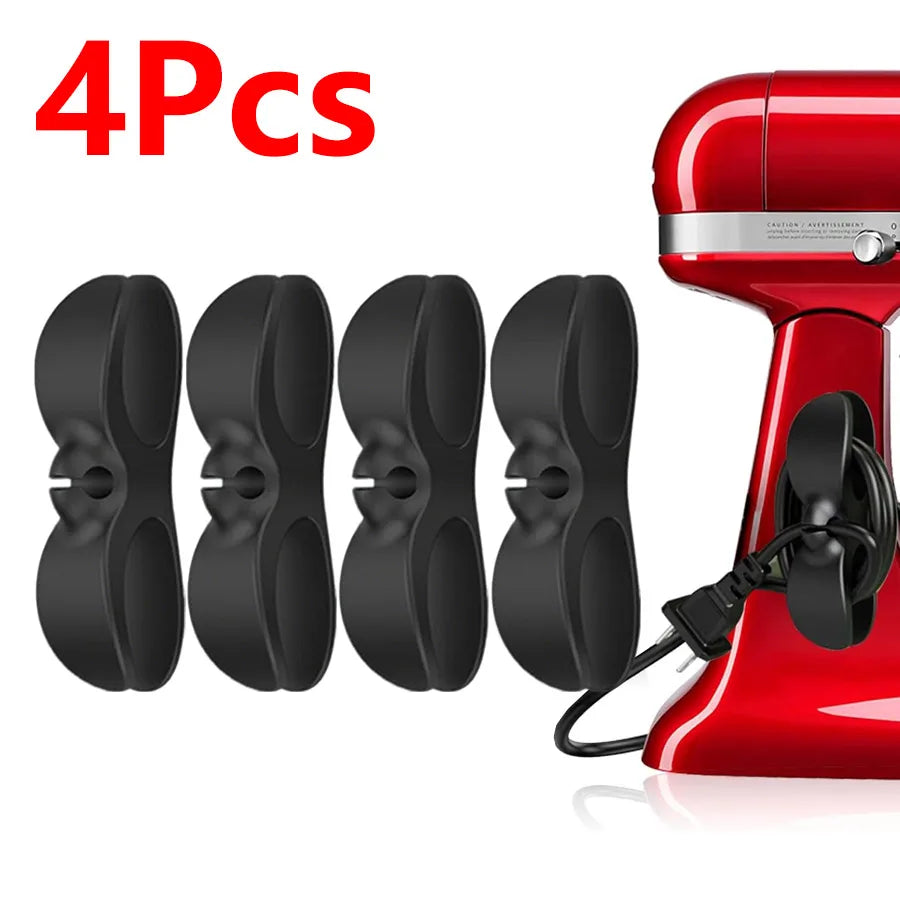 Four black adhesive cord organizers for kitchen appliances shown next to a red appliance.