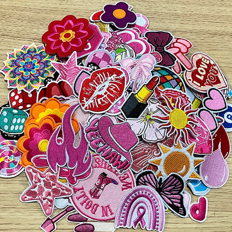 A collection of pink themed embroidered cartoon iron-on patches featuring various shapes and designs.