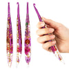 A hand holds a set of purple epoxy resin floral-patterned crochet hooks.