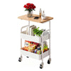 A white 3-tier rolling utility cart with a wooden top holding a vase of red roses and a cup.