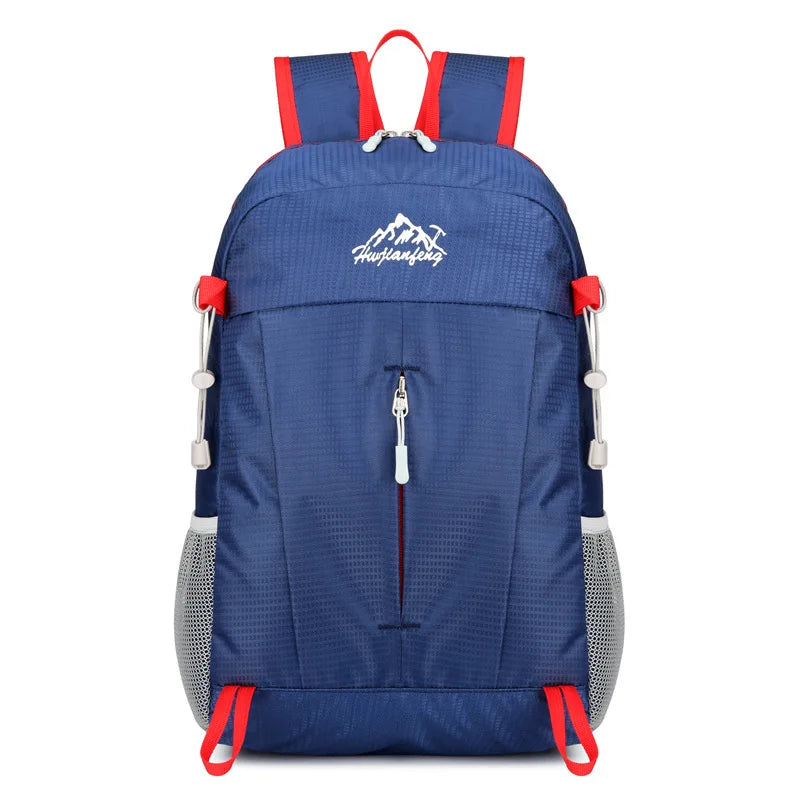 Navy blue ultra-light foldable travel backpack with red accents and mesh pockets