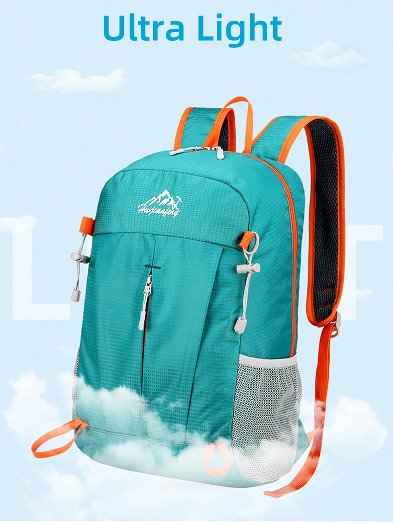 A teal ultra-light foldable travel backpack with orange straps and a white cloud design.