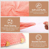 A pink waffle weave microfiber hair drying towel with a double button closure.