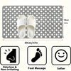 A gray anti-slip shower mat with drainage holes and massage points, shown next to a pair of white flip-flops.
