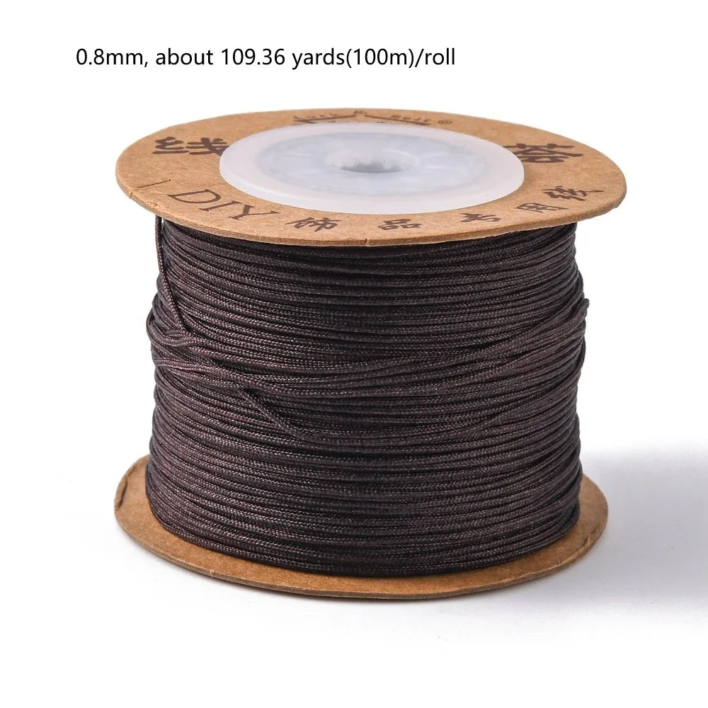 A spool of 0.8mm dark brown nylon cord for jewelry making and crafting with a white core.