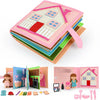 A pink felt quiet book for toddlers with various wooden and fabric components.
