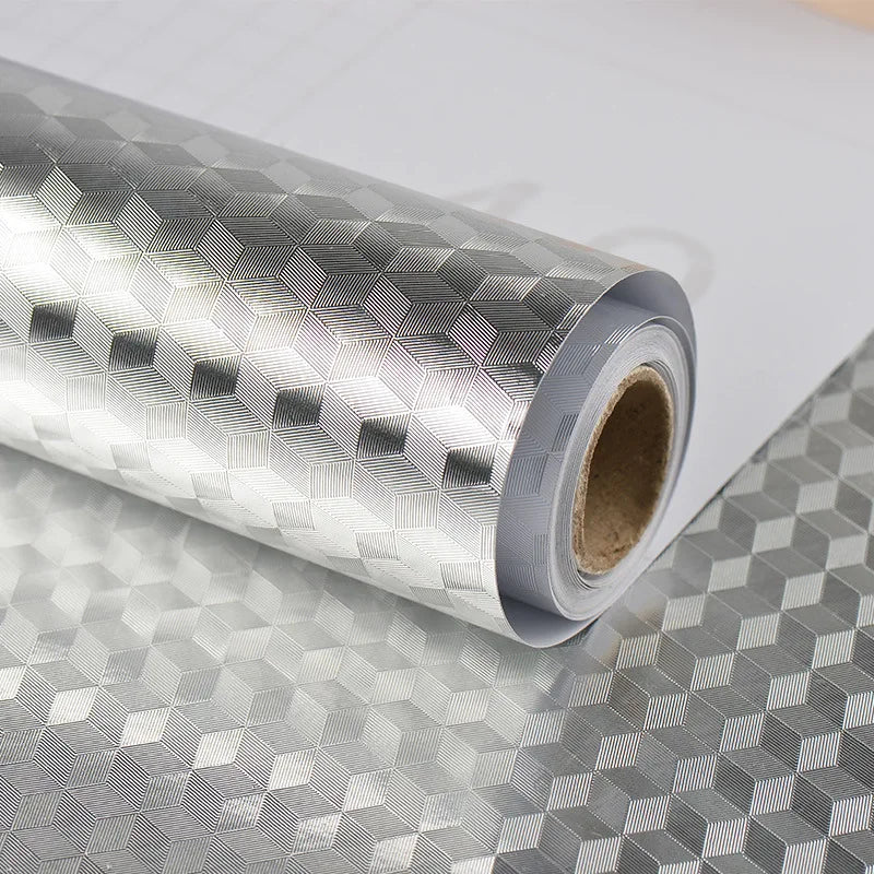 Roll of self-adhesive aluminum foil kitchen backsplash protector with a textured, diamond pattern.