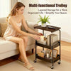 A woman sits next to a multi-functional trolley with layered storage on a living room floor.