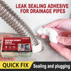 A hand holds a tube of epoxy putty for drainage pipes next to a white container and a piece of white putty.