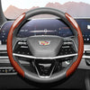 A close-up view of a glossy carbon fiber steering wheel cover inside a car cockpit.