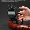 A hand holds a glossy carbon fiber steering wheel cover, demonstrating the light and thin design.