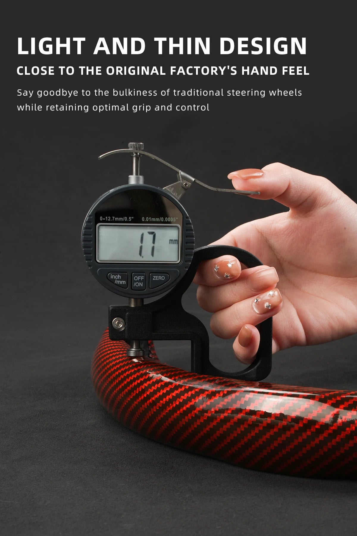 A hand holds a glossy carbon fiber steering wheel cover, demonstrating the light and thin design.