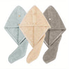 Three folded ultra-soft microfiber hair drying towels in light blue, beige, and gray.