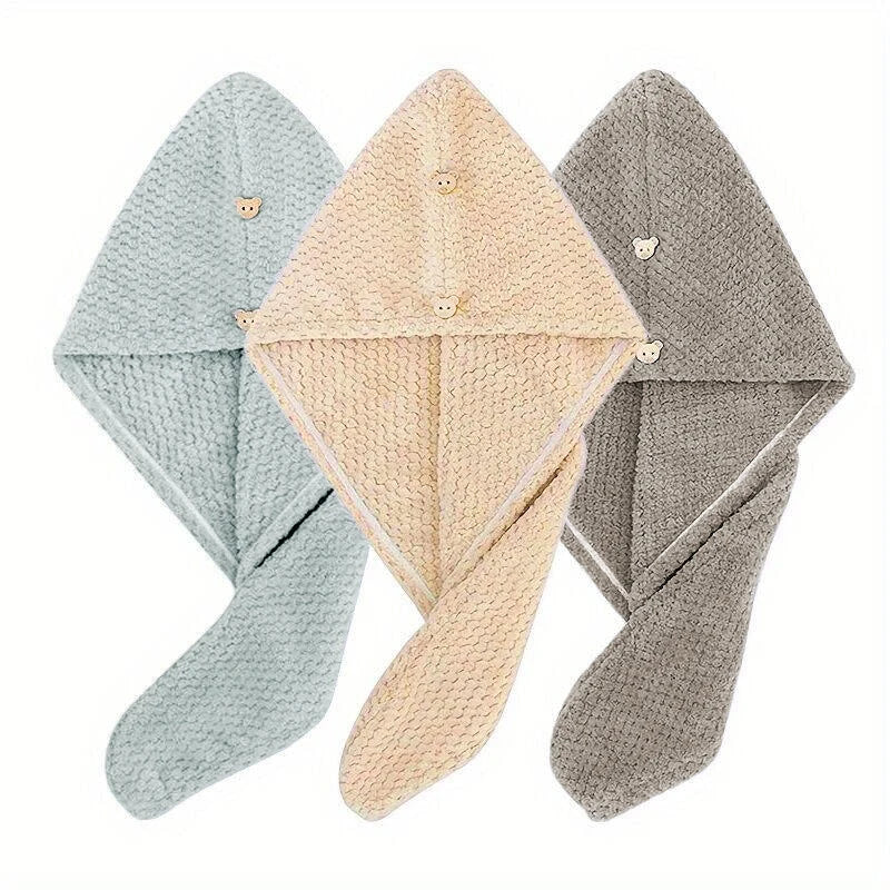 Three folded ultra-soft microfiber hair drying towels in light blue, beige, and gray.