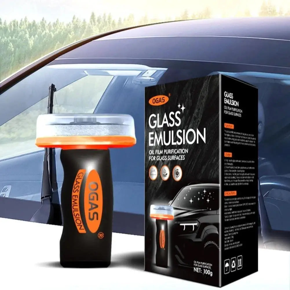 Box of OGAS Glass Emulsion oil film purification cleaning brush for glass surfaces next to a car window.