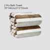 Two stacked striped bath towels featuring brown and white colors.