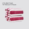 A stack of two pink and white striped bath towels.