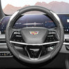 A close-up view of a glossy carbon fiber steering wheel cover inside a car cockpit.