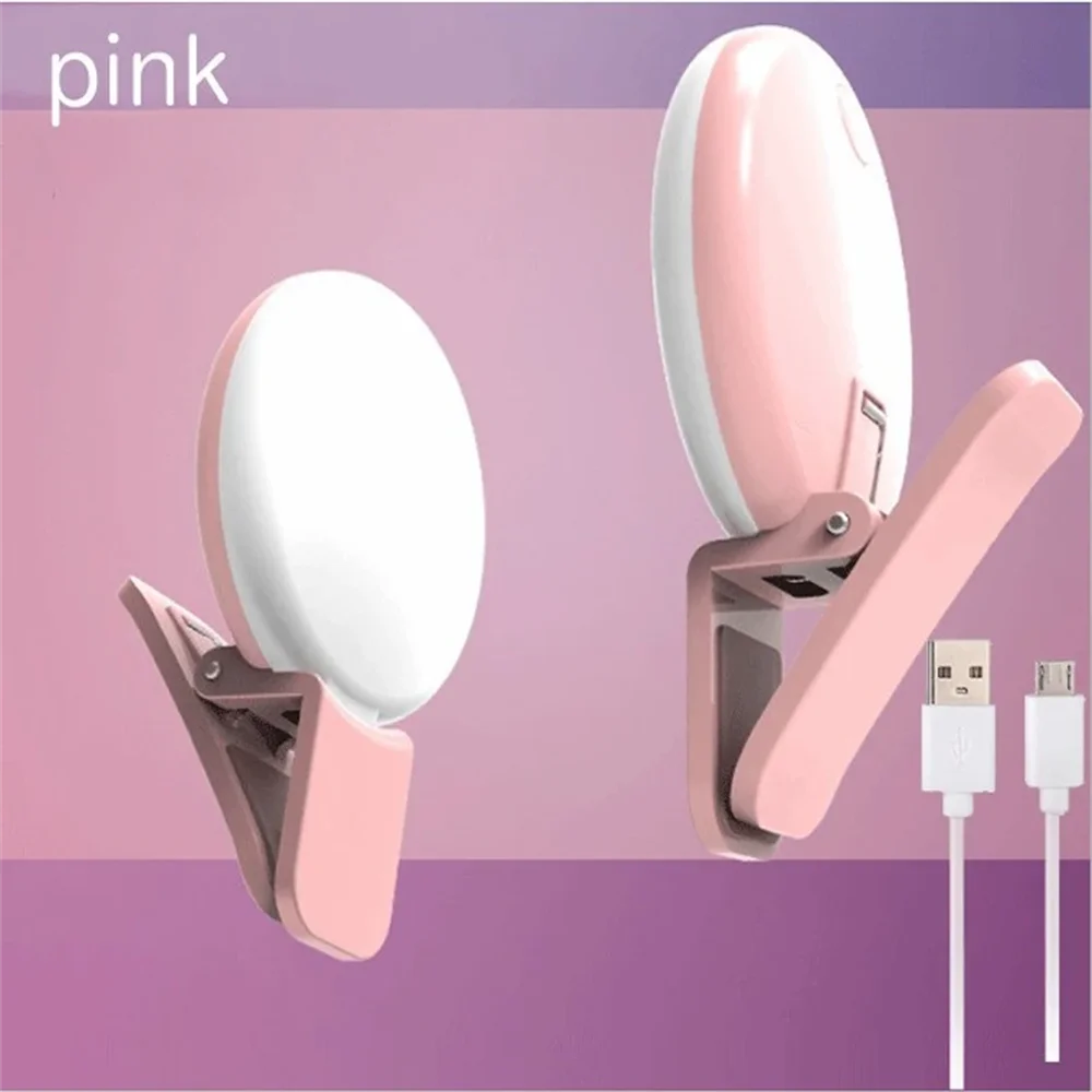 Pink mini clip-on LED selfie ring light with a white circular light head and pink clip.