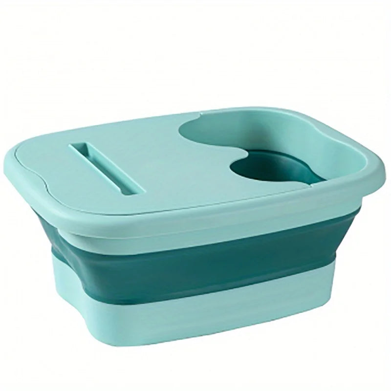 A teal collapsible foot spa bucket with two massage nodules.
