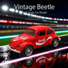 A red vintage Beetle scale model car is displayed on a wet surface with Coca-Cola branding visible.