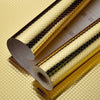 Roll of self-adhesive aluminum foil kitchen wall stickers showing a textured, gold-colored surface.