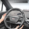 A hand is holding an ultra-thin design steering wheel cover for a vehicle interior.