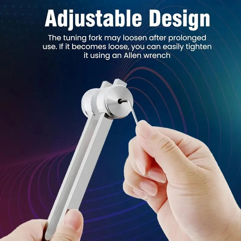 A hand is tightening a silver tuning fork using an Allen wrench to adjust its design.