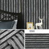 A roll of striped peel-and-stick wallpaper featuring dark gray and black vertical stripes.