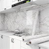 Marble peel-and-stick wallpaper applied to kitchen cabinets and countertops.