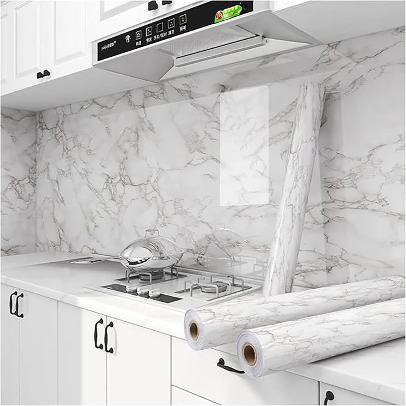 Marble peel-and-stick wallpaper applied to kitchen cabinets and countertops.