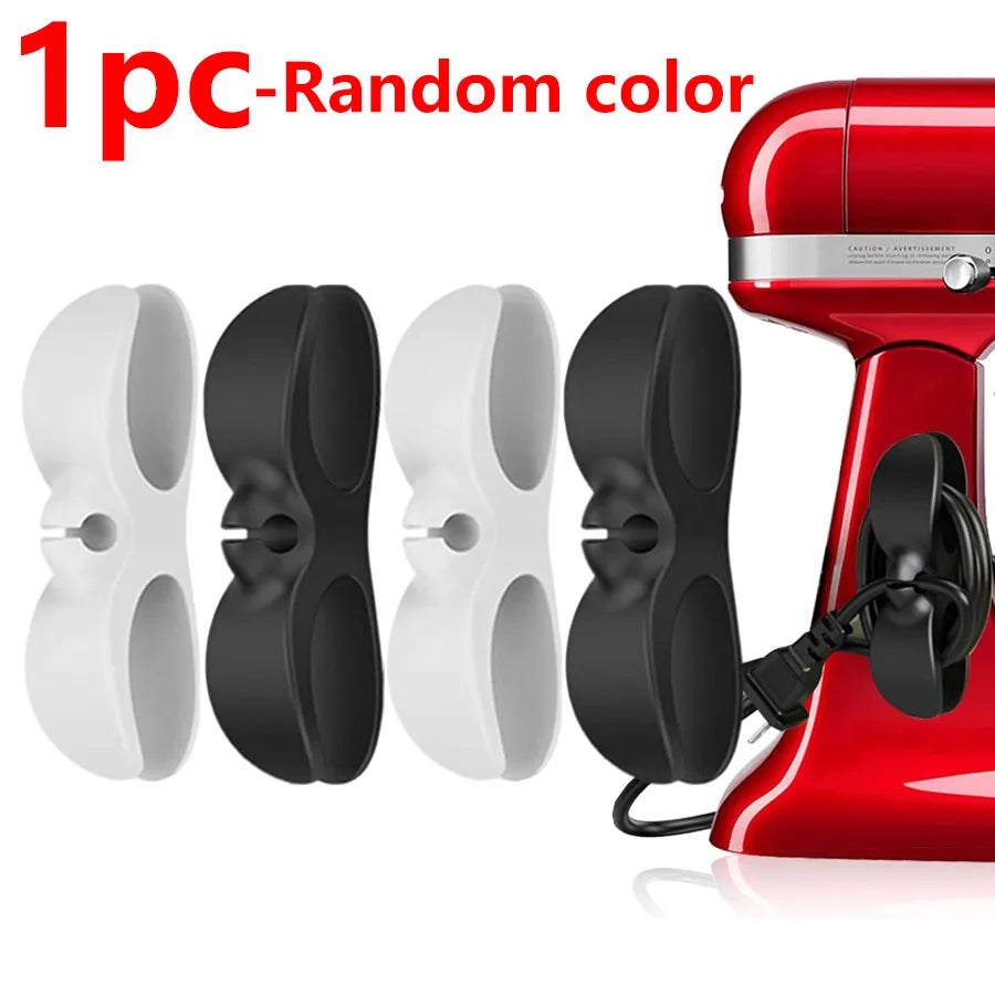 Three black and white adhesive cord organizers shown next to a red appliance.