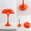 Orange mushroom-shaped LED table lamp with a slender stem and touch control features