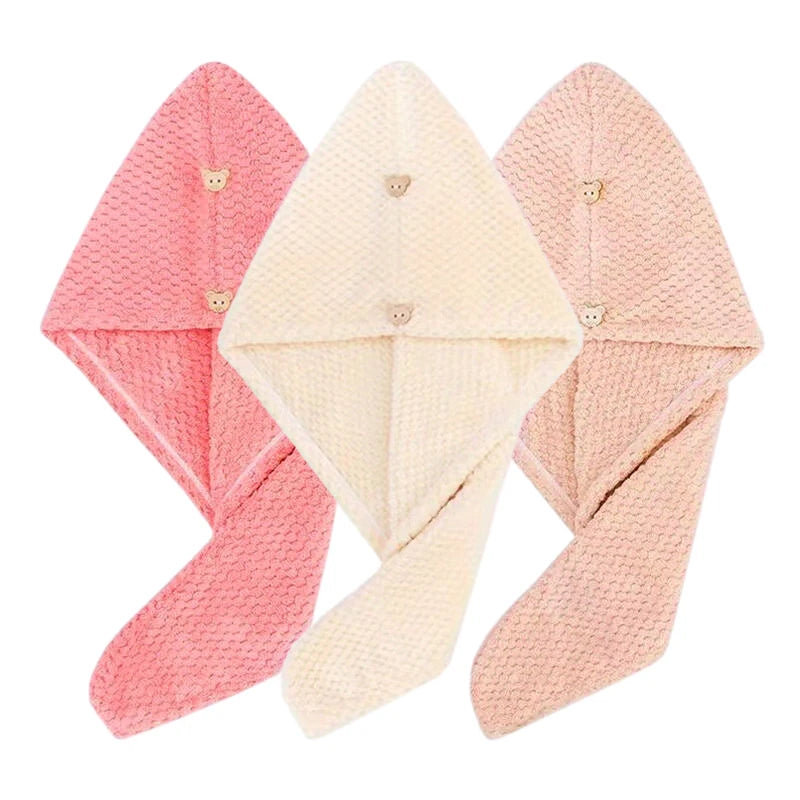 Three folded pink and beige microfiber hair drying towels with secure button closures